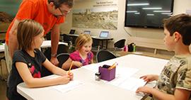 Image: A family learns how to write their names in hieroglyphs.