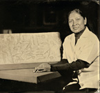 Gloria Margarita Tovar is a nail technician at the Elizabeth Arden Red Door Salon in Chicago. She is shown with an architectural element from the tomb of an Overseer of the Palace Manicurists, ca. 2430 BC. OIM E10815.